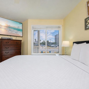 Plush pillows and crisp sheets invite you to unwind on the queen bed in the master suite