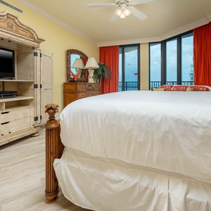 Master suite bedroom with a king bed, stylish furnishings, and large windows for a refreshing view