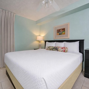 Tranquil bedroom suite featuring a king bed and wall-mounted TV