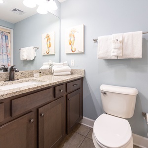 Freshen up in this guest bath in the relaxing shower or soothing tub before an exciting beach day