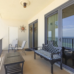 Step onto the balcony to relax on stylish seating while enjoying breathtaking views of the shimmering coastline