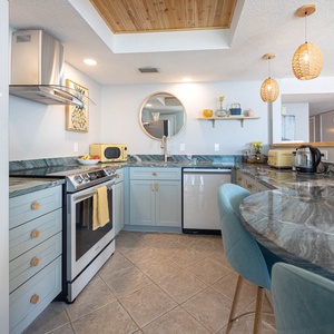 The kitchen features upgraded smart appliances, beautiful countertops, and a cozy breakfast bar for morning coffee