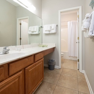 Brighten your day in this spacious master bath featuring a large vanity, ample towels, and a relaxing tub-shower combo