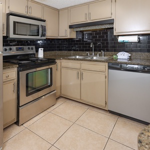 Cook with ease in the stylish kitchen featuring stainless appliances, granite countertops, and ample storage space