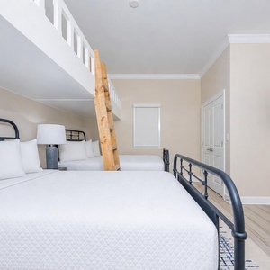 Sleep comfortably in this cozy room with two queen beds, two lofted twin beds, and a TV for your favorite show