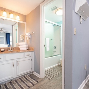 The master bath features a stylish vanity with ample counter space, a tub/shower combo, and fresh towels for your convenience