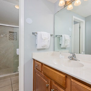 Refresh in the master bathroom featuring a spacious walk-in shower, large mirror, and ample counter space