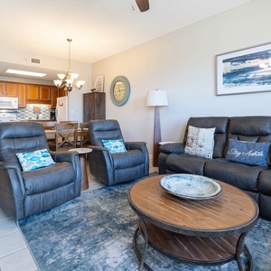 Comfortable living space, featuring a stylish coffee table and a view of the inviting kitchen