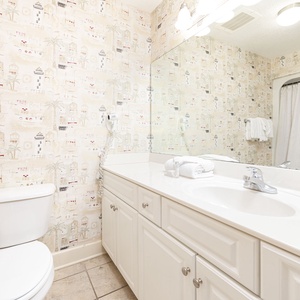 Freshen up in this guest bath in the relaxing shower or soothing tub before an exciting beach day