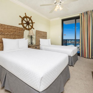 Guest suite with two twins offers serene water views through sliding doors to your balcony