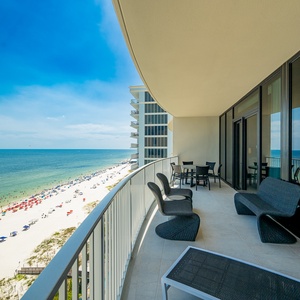 Enjoy the spacious balcony with stylish seating, perfect for relaxing while taking in the beach views below
