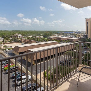 The master balcony offers a view of the surrounding greenery and nearby surroundings, perfect for enjoying the fresh air