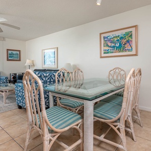 Dine at the glass-top table surrounded by tropical decor, with inviting seating and views enhancing your experience