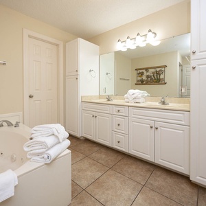 Indulge in relaxation in the master bath with a refreshing walk-in shower and soothing jetted tub