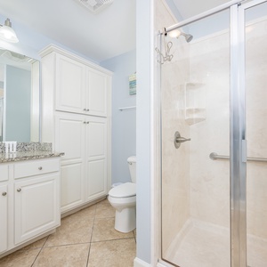 Refresh and unwind in the guest bathroom with a bright vanity and easy-access walk-in shower