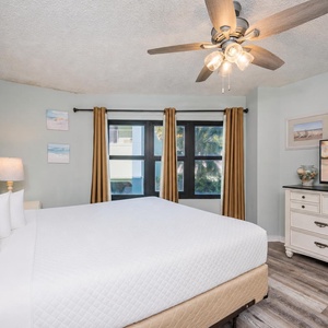 Soft light fills the master suite with a king bed as you unwind and watch a sunset on the TV screen