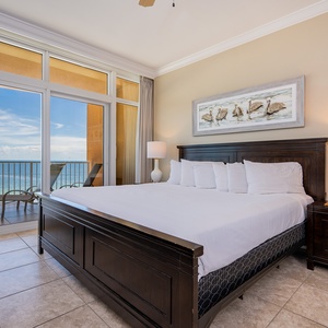 Serene master bedroom featuring a king bed, stylish decor, and beachfront balcony access