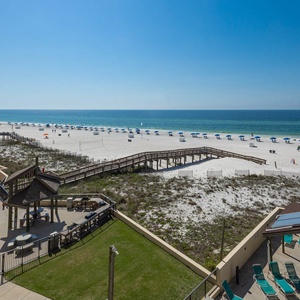 This stunning beach view showcases inviting lounge chairs by the pool, perfect for relaxation and enjoyment