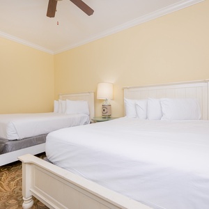 Soothing guest bedroom featuring two cozy queen beds and soft, neutral decor for a relaxing stay