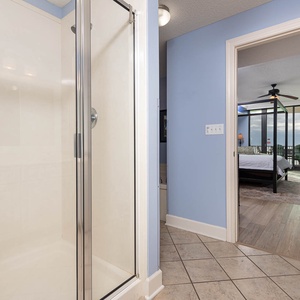 Step into the master bath featuring a walk-in shower, jetted tub, and elegant place to refresh after a beach day
