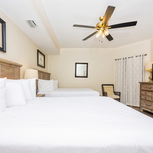 Relax on one of the cozy queen beds in this guest suite and enjoy a peaceful slumber