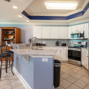 Prepare meals with ease in this spacious kitchen featuring sleek modern appliances and ample counter space for gatherings
