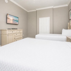 Unwind in the queen guest suite, where plush bedding invites restful nights and gentle light fills the space