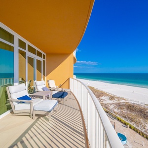Lounge on cushioned chairs on the balcony, feeling the sun and watching the gulf and soft white sand
