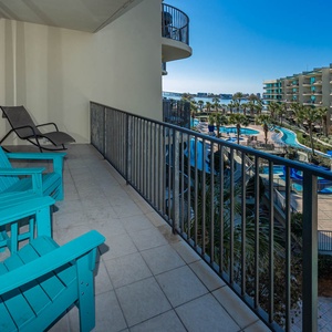 Lounge on the balcony overlooking the refreshing pool, lazy river, stunning bay water, and marina activity