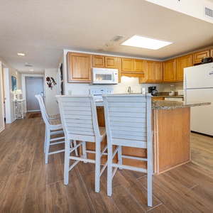Gather around the kitchen bar with seating for casual meals and enjoy the open layout that enhances your stay
