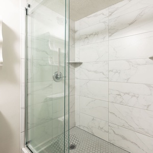 Refresh in the stylish walk-in shower in the master, enjoying the soothing flow of water after a beach day