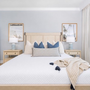 Retreat to this master suite featuring a king bed, stylish decor, and stunning beach views