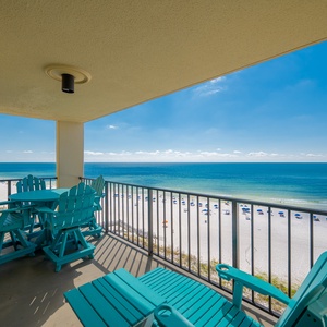 Relax on the turquoise balcony chairs while enjoying breathtaking views of the beach and sparkling waters