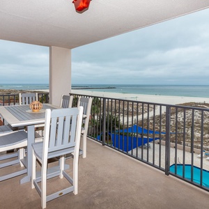 Savor meals or drinks on the balcony while enjoying views of the beach and nearby pool area