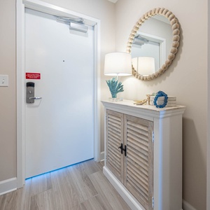 Step into a welcoming entryway featuring a stylish console, decorative accents, and soft lighting for a warm arrival