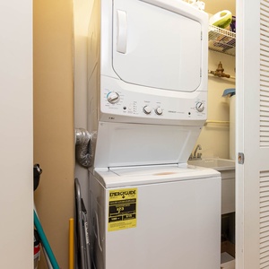 The laundry area features a stacked washer and dryer, providing convenience for guests during their stay
