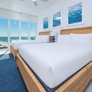 Wake to a breathtaking sunrise in this queen guest suite with two cozy beds and expansive views from the windows
