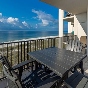 Balcony seating offers a serene view of the tranquil beach and sparkling gulf waters, perfect for relaxation