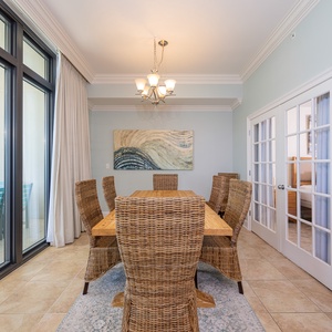 Gather around the inviting dining table, enjoying laughter and cherished moments in a vibrant coastal vibe