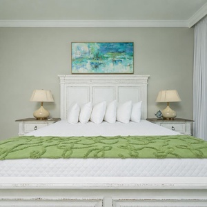 Inviting master bedroom, featuring a plush king bed with soft pillows and soothing coastal decor
