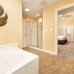 Sink into the jetted tub for a soothing soak, or enjoy a refreshing shower in this serene master bath