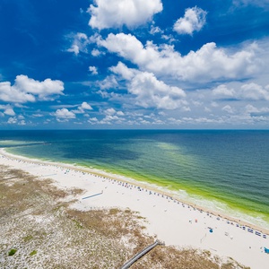 Breathe in the fresh coastal air from your spacious balcony, enjoying stunning views of the tranquil shore