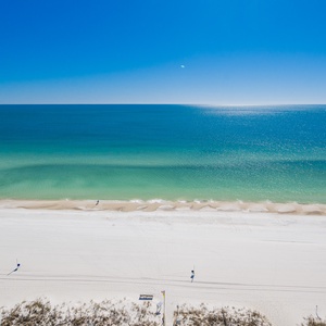 Gaze at the tranquil waters and shoreline while enjoying the refreshing breeze from your balcony retreat