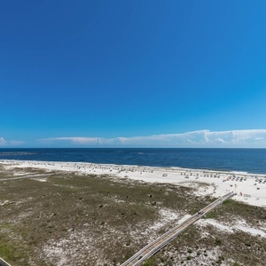 Stunning view of the beach dotted with umbrellas and chairs, under a clear blue sky