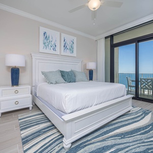 Serene master bedroom featuring a king bed, stylish decor, and a beach view that invites relaxation