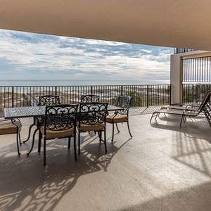 Relax on the spacious beachfront balcony, perfect for meals or sunbathing with a view of the tranquil waters