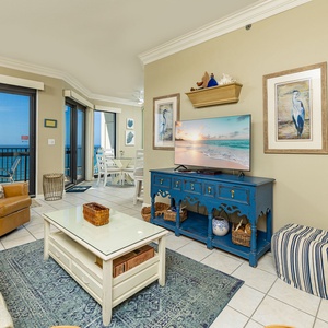 Natural colors soothe your senses in the living room as coastal views stretch beyond your balcony doors