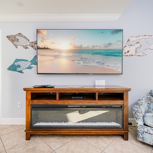 Relax on the plush couch, streaming your favorite shows while enjoying a cozy ambiance from the fireplace