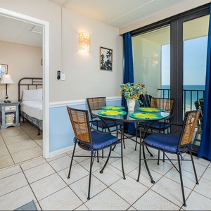 Gather around the cheerful glass table with loved ones, sipping drinks while soaking in the coastal views