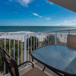 Relax with stunning beachfront views from the balcony, complete with a glass table and comfortable seating for relaxation